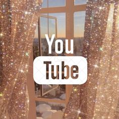 a window with glitter curtains and the words you tube on it