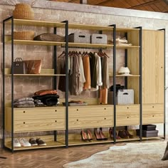 an open closet with clothes and shoes on shelves next to a bed in a room