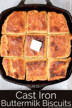 a square pan filled with baked bread and topped with butter cubes, on top of a white wooden table