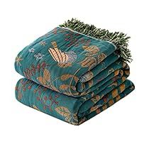 three blankets stacked on top of each other with pine needles sticking out of the ends