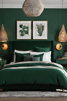 a bed with green sheets and pillows in a room that has two pictures on the wall