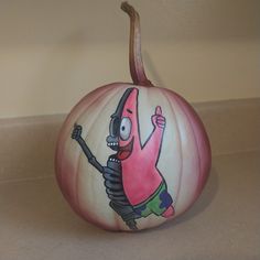 a painted pumpkin with a cartoon character on it's face and arms in the air