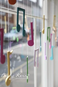 musical notes hanging from the side of a window