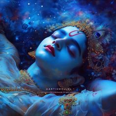 a woman with blue makeup and gold jewelry laying on the ground in front of a sky background