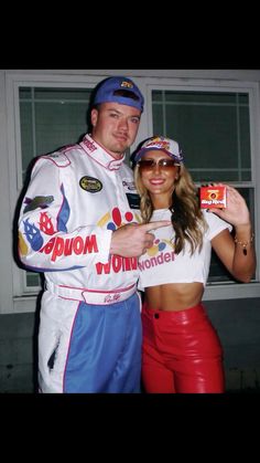 a man and woman dressed in racing gear