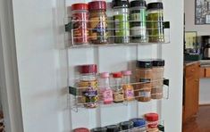 two shelves holding spices and condiments in a kitchen