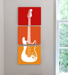 three paintings of guitars are hanging on the wall