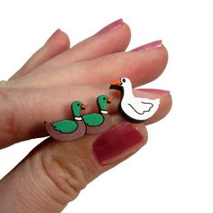 "Everyone has played the fun children's game of Duck Duck Goose and now you can see if anyone catches your humorous style every time you wear these Duck Duck Goose Stud Earrings! 🦆 These Funny Duck Duck Goose studs are made from hand painted laser cut wood! Such amazing detail, when someone looks they will instantly know your hilarious style! 🦆 Each pendant of this pair of funny stud earrings measure about .5\"- .65\" wide. Not too small, not too big! 🦆 Cute double duck and goose earrings are Goose Earrings, Teacher Jewelry Gifts, Teacher Jewelry, Duck Duck Goose, Funny Duck, Duck Duck, Game Themes, Childrens Games, Preschool Games