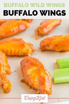 buffalo wings with celery and carrots on a sheet of waxed paper