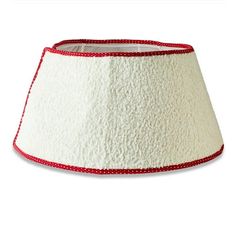 a white lamp shade with red trim on the bottom and bottom, is shown in front of a white background