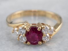 Timeless simplicity! This deeply colored red ruby sits in a simple four-prong setting, crafted of yellow gold. The polished gold really lets the color of the ruby stand out, and the lovely diamond accents add amazing sparkle and elegance to the ring! This could make a great engagement ring, or just as a ring for any occasion! Metal: 14K Yellow Gold Gem: Ruby .74 Carats Gem Measurements: 5.7 x 4.8 mm, Oval Accents: 6 Diamonds totaling .36 Carats, G in Color, VS in Clarity Ring Size: 6 Marks: ".36 Yellow Gold Ruby Ring With Diamond Accents, Ruby Wedding Ring Set, Ruby Ring Designs, Antique Ruby Ring, Gold Ruby Ring, Yellow Gold Sapphire Ring, Ruby Ring Vintage, Engagement Ring Yellow Gold, Timeless Simplicity