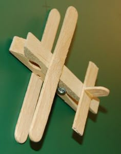 a small wooden cross on a green surface