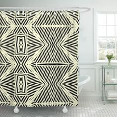 a black and white shower curtain with an abstract design in the middle, next to a bathtub