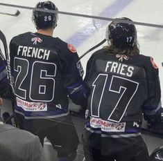 three hockey players are sitting on the bench