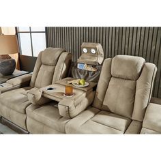 two reclining chairs with a tray on one side and an end table in the other