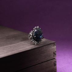 This gorgeous sterling silver ring is perfect for a person with a flare for vintage jewelry. The Blue Sapphire Peacock Vintage Ring features an oval blue sapphire as its centerpiece, encircled by small round white diamonds that catch the light gloriously and radiate life! From cornflower blue to velvety blue, there are multifarious shades of blue sapphire that gives it a silky tint. Characterized by the power of Shani or Saturn, Blue Sapphire displays violet to indigo and pale blue as well as da Puka Shell, Royal Blue Color, Cornflower Blue, Vintage Ring, Well Being, Estate Jewelry, Diamond White, Shades Of Blue, Vintage Rings