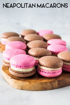 pink and chocolate macaroons on a wooden platter with the words neapolitan macarons