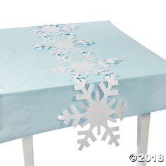 a snowflake tablecloth with white snow flakes on it