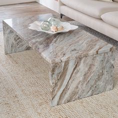 a marble coffee table sitting on top of a rug