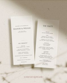 two wedding program booklets sitting next to each other on top of a white table