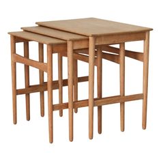 three wooden nesting tables sitting on top of each other