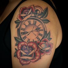 a woman's arm with a clock and roses tattoo on her shoulder, which is also in color