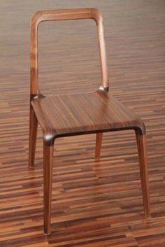 a wooden chair sitting on top of a hard wood floor