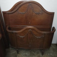 a wooden headboard and foot board in a room