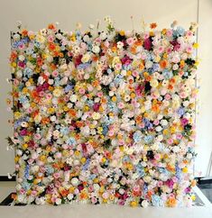 a wall made up of many different colored flowers