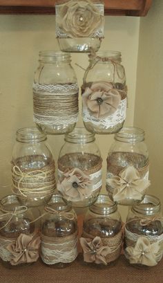 there are many glass jars with flowers in them