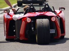 a person riding on the back of a red race car