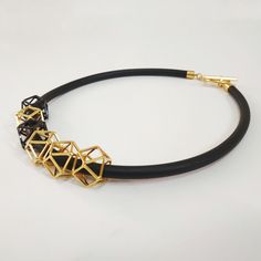 "An elegant black and gold geometric necklace on black silicon cord. Unique geometric elements and a toggle clasp. This necklace will upgrade any outfit! You can wear it with a plain white t-shirt and your favorite pair of jeans all day long at work, or with a small black dress on the evening when you celebrate life! Find out which way you like it the best! * * * * * * * * * * * Materials: 0.24\"/6m\"m thick black silicon cord gold plated pewter gold plated toggle clasp & elements Toggle cla Black Geometric Jewelry, Adjustable Geometric Black Jewelry, Adjustable Black Geometric Jewelry, Modern Black Geometric Necklace, Gold Geometric Necklace, Plain White T Shirt, Geometric Elements, Special Necklace, Small Black Dress