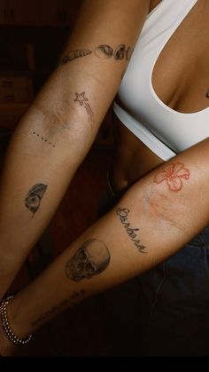 two women with tattoos on their arms