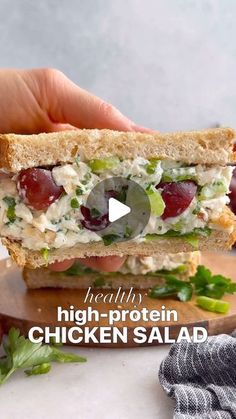 a person holding a sandwich with chicken salad in their hand and the words healthy high protein chicken salad on it