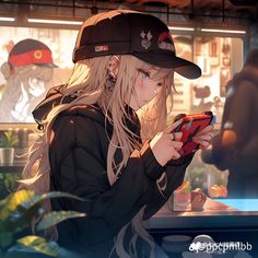 a girl with long blonde hair is looking at her cell phone while standing in front of a counter