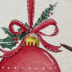 a drawing of a christmas ornament with a red ribbon and holly on it