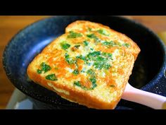 an omelet is being cooked in a skillet