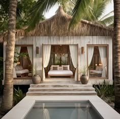 an outdoor bedroom with two beds and a pool in the foreground, surrounded by palm trees