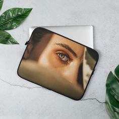 a laptop case with an image of a woman's eye on the front and side