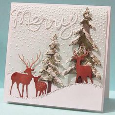 a christmas card with deer and trees on it