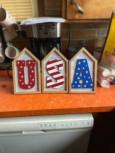 the letters are made out of wood and painted red, white, and blue stars