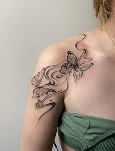 a woman with a butterfly tattoo on her shoulder