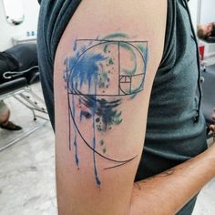 a man with a tattoo on his arm in the shape of a circle and an abstract design