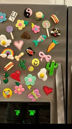 a refrigerator covered in lots of different types of magnets on it's side