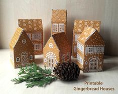 small gingerbread houses with pine cone on table