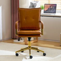 a brown leather office chair sitting in front of a window