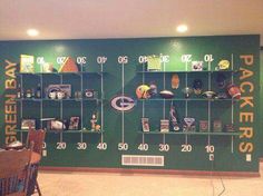 a green wall with football memorabilia on it