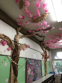 some pink flowers are hanging from the ceiling