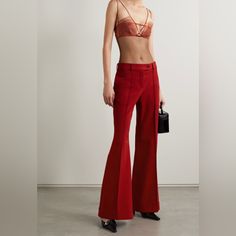 Acne Studios' Tailored From Red Twill That's Blended With Wool And A Hint Of Stretch For A Non-Restrictive Fit. They're Cut To Sit On The Waist And Have Flared Legs Traced With Elongating Center Seams Before Falling To Cuffed Hems. Red Fitted Pants For Evening, Red Wide Leg Bottoms For Evening, Evening Fitted Red Pants, Red High Waist Evening Pants, Red High Waist Pants For Evening, High Waist Red Pants For Evening, Elegant Red Flare Bottoms, Chic Red Formal Bottoms, Tailored Red Wide Leg Pants