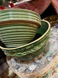 a green bowl sitting on top of a table